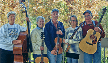 Buck Mountain Band hold their instruments and pose for a photo