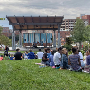 Trio plays on amphitheater stage at Bailey Park