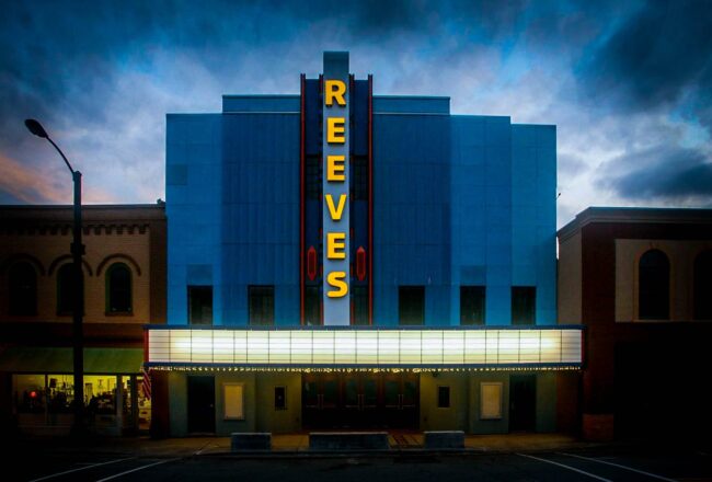 Outside of the Reeves Theatre with lights on at night