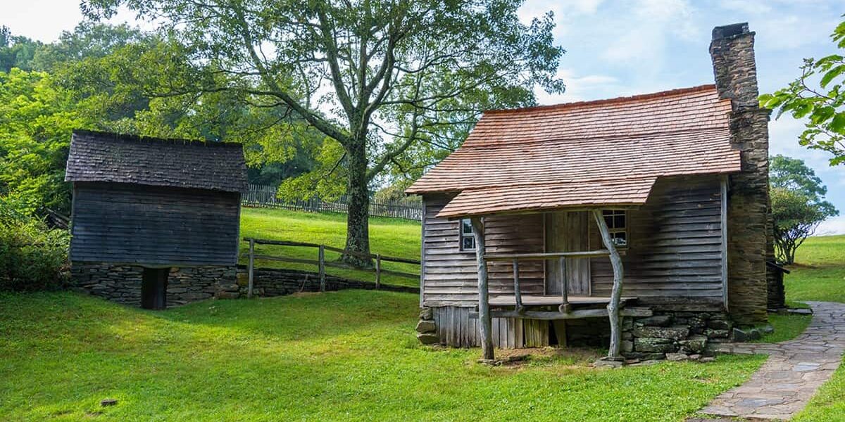 Brinegar Cabin sits on bright green grass