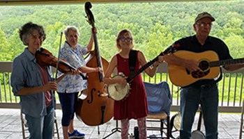 Miss Ellie and the Buck Mountaineers playing music and smiling