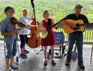 Miss Ellie and the Buck Mountaineers playing music and smiling