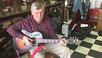 Jim Lloyd playing acoustic guitar